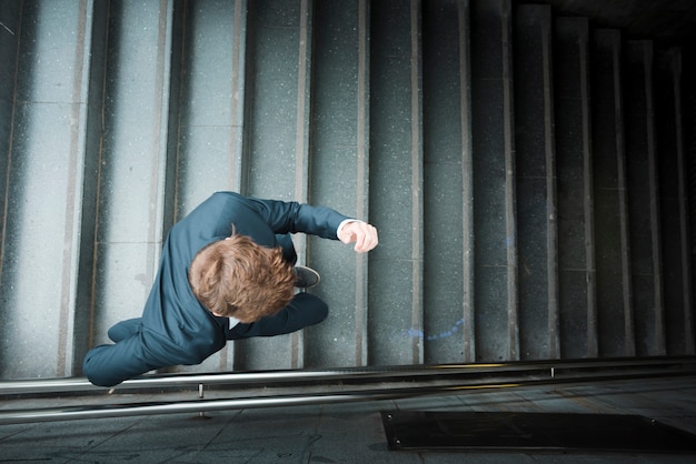 Free photo an elevated view of a businessman running downstairs