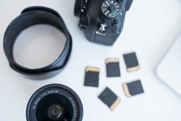 Free photo elevated view of camera accessories with memory cards on desk