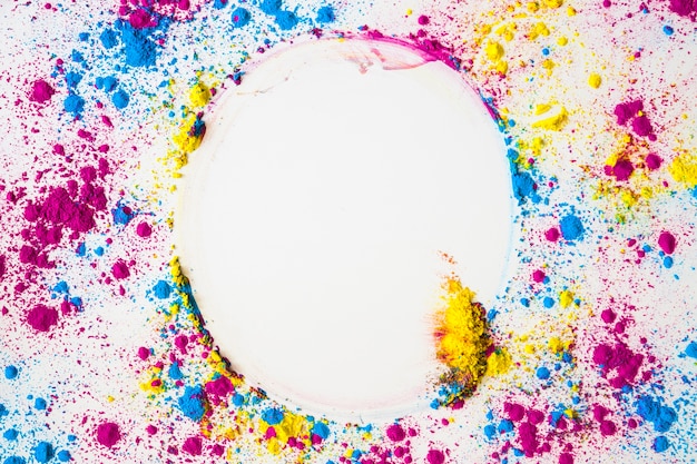 Free photo elevated view of colorful face powder forming circular frame on white surface