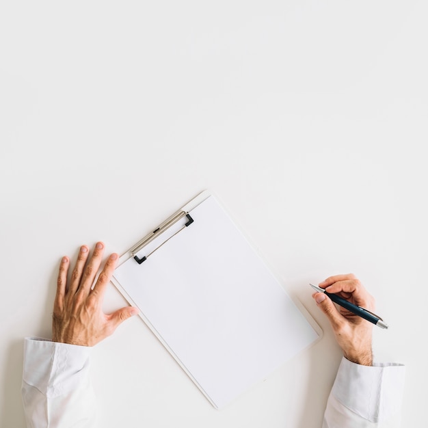 Free Photo elevated view of doctor's hand with blank white paper