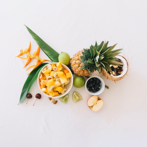 Elevated view of fresh tropical fruits on white background