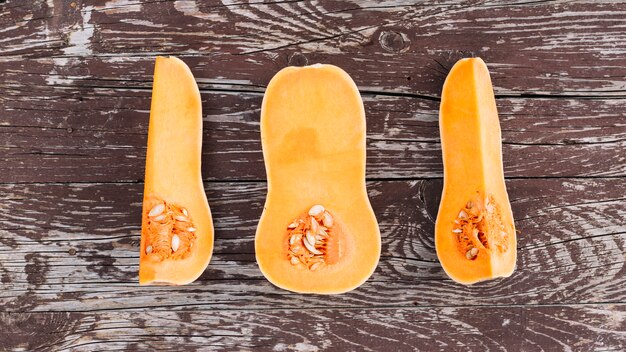 An elevated view of halved squash on wooden table top