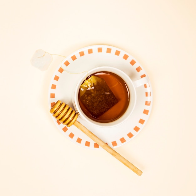 Elevated view of healthy tea with honey dipper