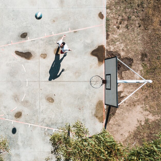 Elevated view of man playing with basketball