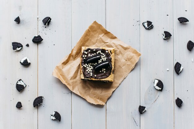 Elevated view of pastry and cookie pieces on wooden surface