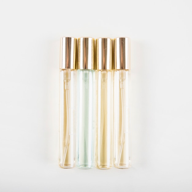 Free Photo elevated view of perfume bottles on white backdrop