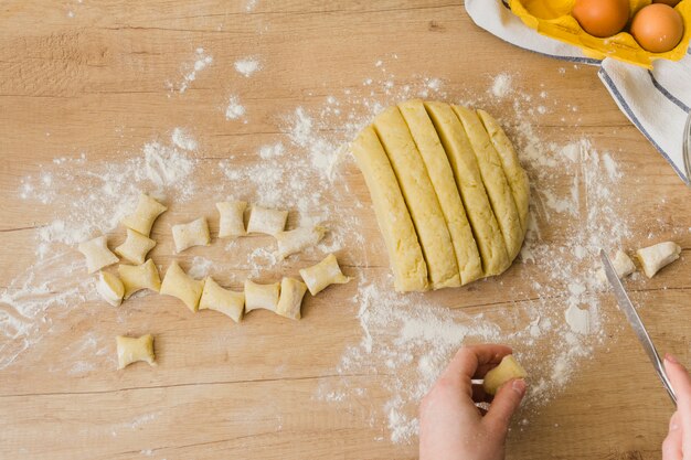 An elevated view of a person preparing the homemade italian pasta gnocchi