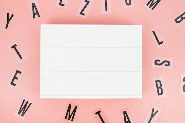 Free Photo elevated view of placard surrounded by various black alphabets