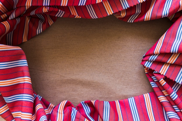 Elevated view of stripped pattern cotton textile on sack cloth