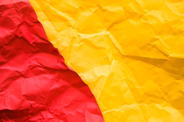 Elevated view of two red and yellow crumpled papers