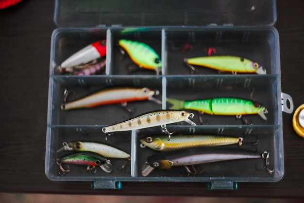 Free photo elevated view of various fishing lures in box