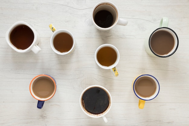 Free photo elevated view of various kinds of coffee in cups on desk