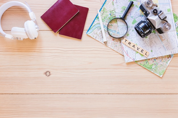 Elevated view of various traveler accessories on wooden surface