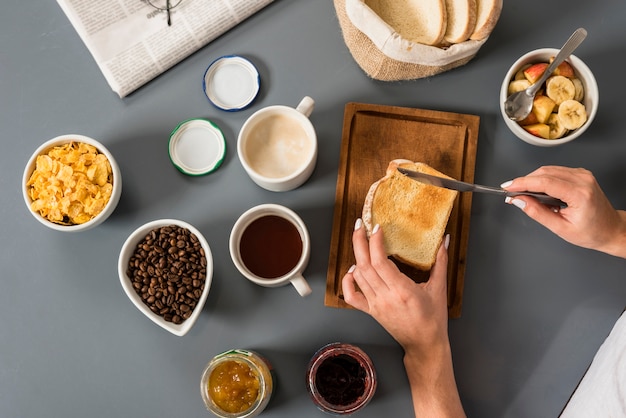 Free Photo an elevated view of woman's hand having breakfast