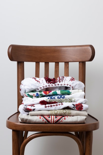 Free photo embroidered shirts on chair arrangement