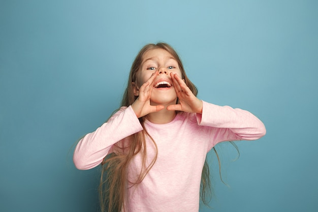 Free photo the emotional blonde teen girl have a happiness look and screaming. studio shot