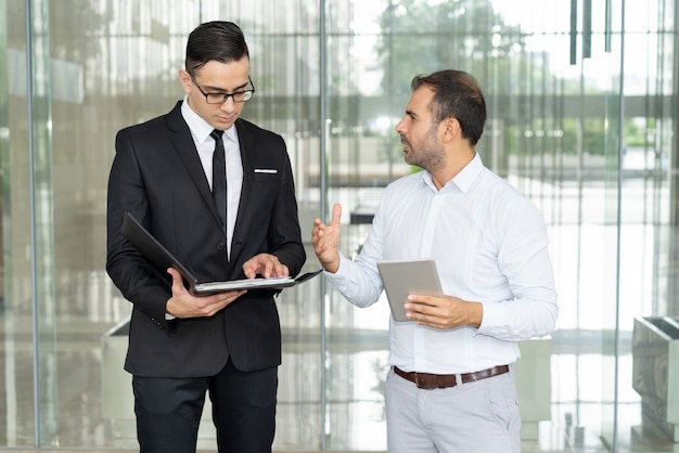 Emotional businessman with tablet proving his point