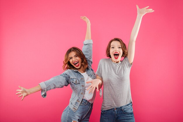 Emotional excited two women friends