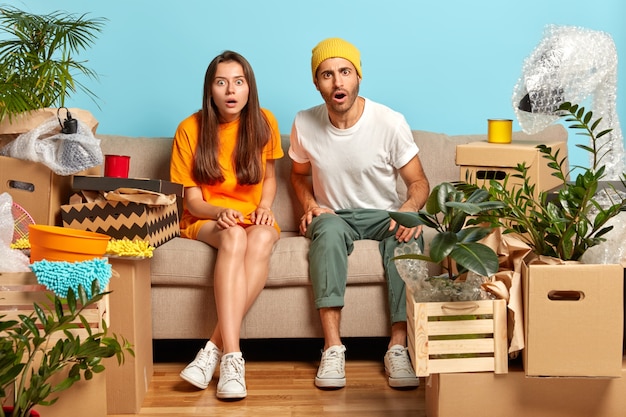 Emotional two shocked woman and man stare with bugged eyes