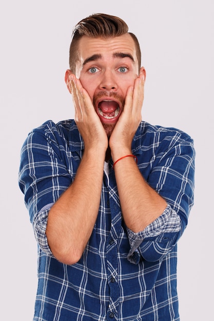 Emotions. Young man in blue shirt