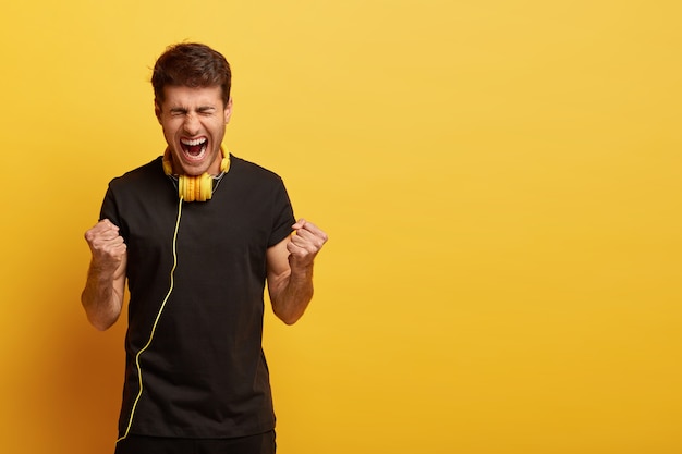 Emotive European man with dark hair, wears black t shirt, cannot imagine life without music