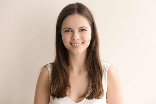 Emotive headshot portrait of cheerful young woman