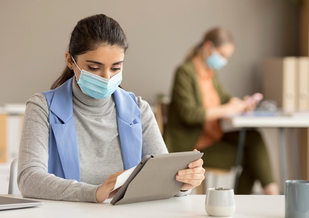 Employee disinfecting electronic device