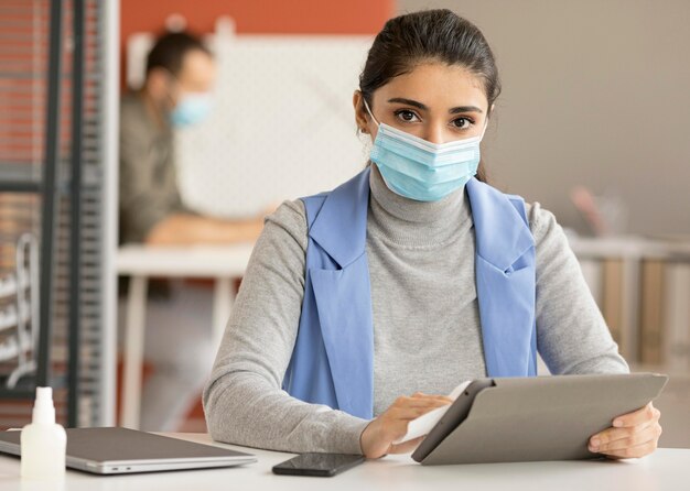 Employee disinfecting electronic device