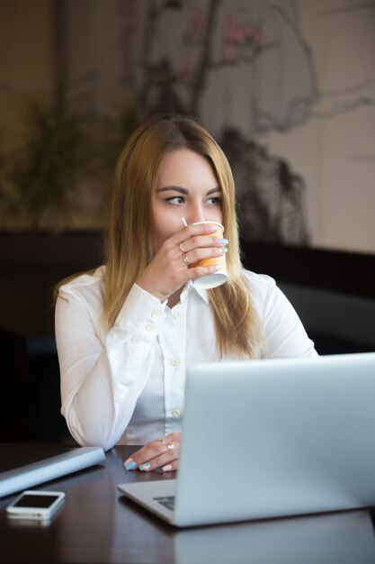 Employee enjoying a coffee while working