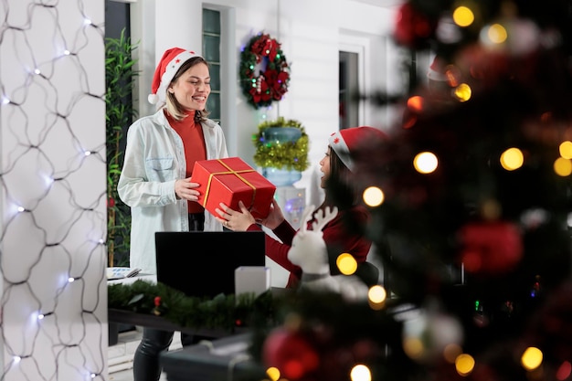 Free photo employee receiving gift from colleague