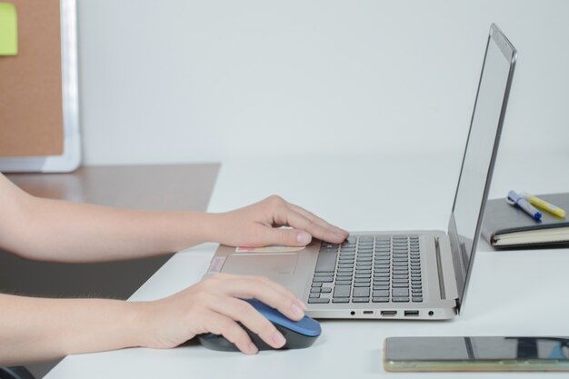 Employee working at grey laptop in the office