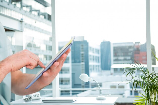 Employee working in his office with a tablet