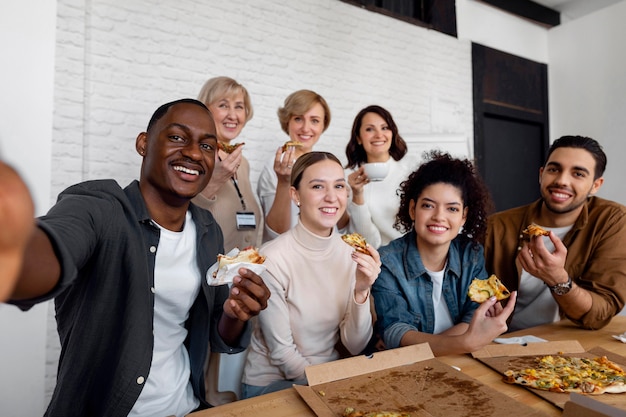 Employees eating pizza at work