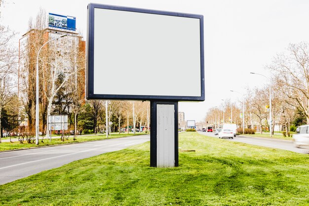 An empty billboard in the middle of city road