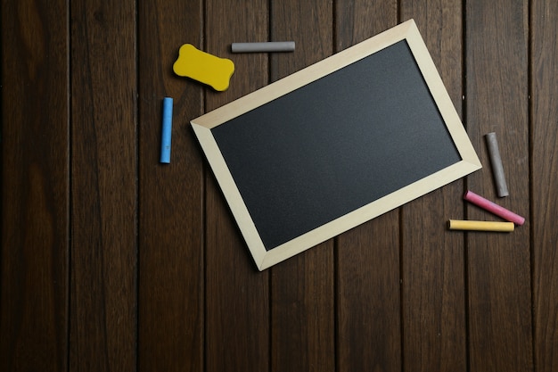 Free photo empty blackboard on vintage wooden background