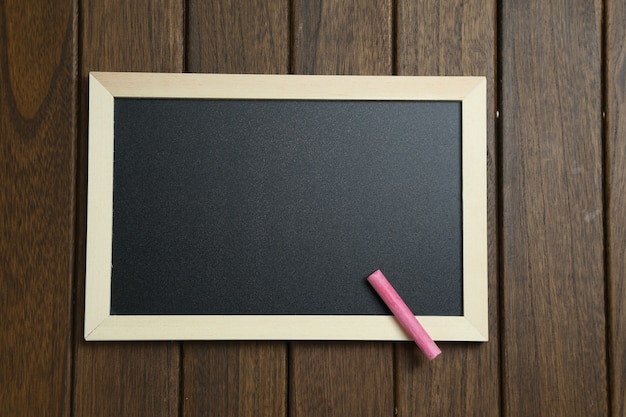 Free photo empty blackboard on vintage wooden background