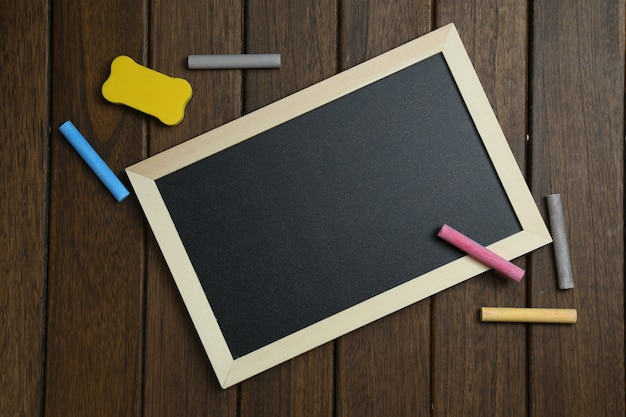 Free photo empty blackboard on vintage wooden background