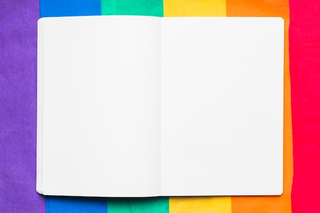 Free Photo empty copybook on rainbow background