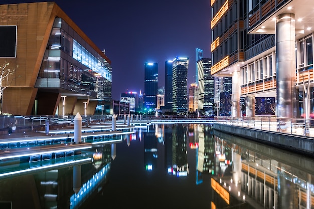 Empty floor with modern skyline and buildings at night in Shanghai