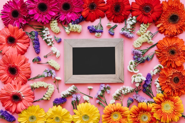 Free photo empty frame in different colorful flowers