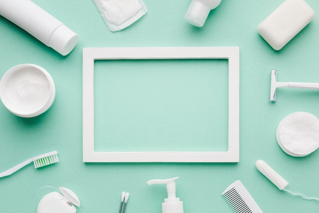 Free Photo empty frame surrounded by hygiene products