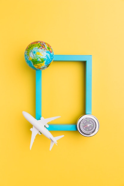 Free Photo empty frame with plane and globe