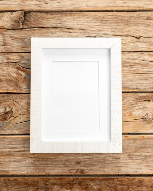 Empty frame on wooden wall