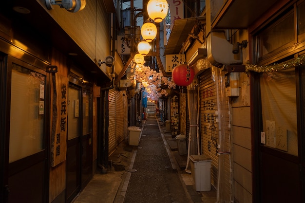 Empty narrow street with lights