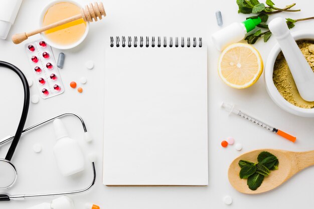 Empty notepad surrounded by natural and medical treatments