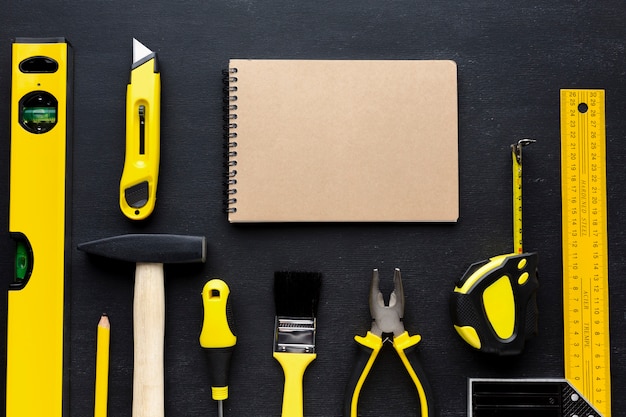 Free Photo empty notepad and yellow repair tools with copy space