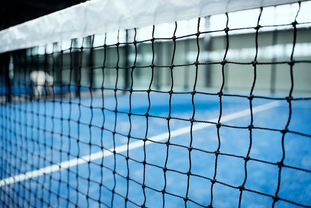 Empty paddle tennis field with net