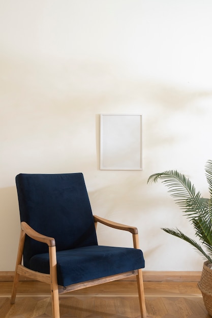 Empty photo frame on wall and blue chair