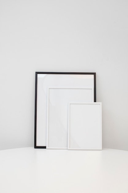 Free photo empty photo frames on white table