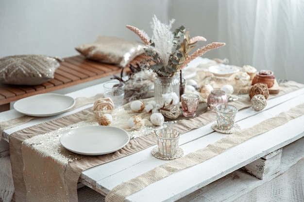 Free Photo empty plates and glasses on a decorated dining table for the easter holiday. beautiful hygge-style table setting.